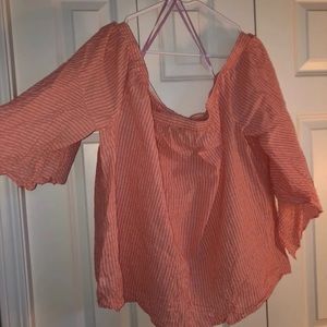 Woman’s pink off the shoulder blouse